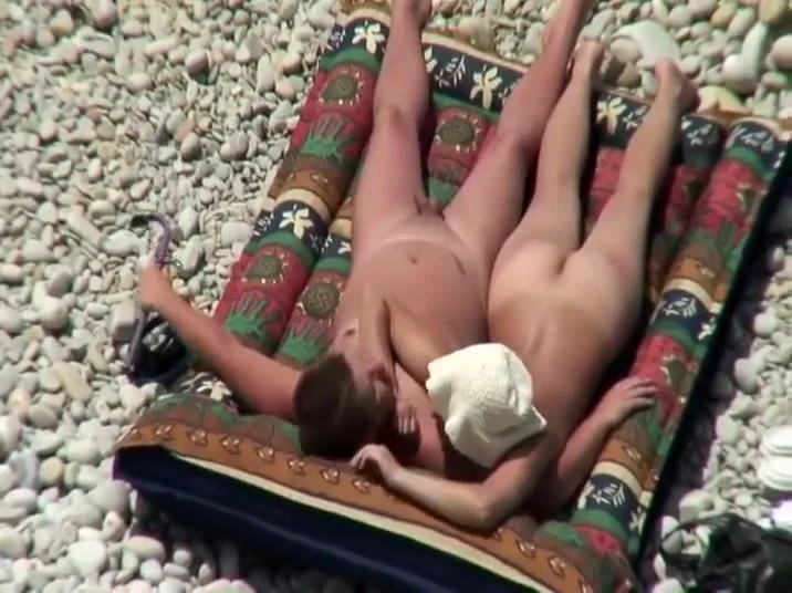 Nudist couple tanning and relaxing