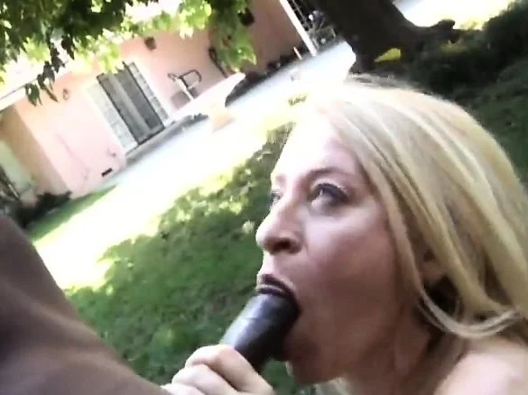 Insatiable blonde milf sucks and strokes a huge black stick outside