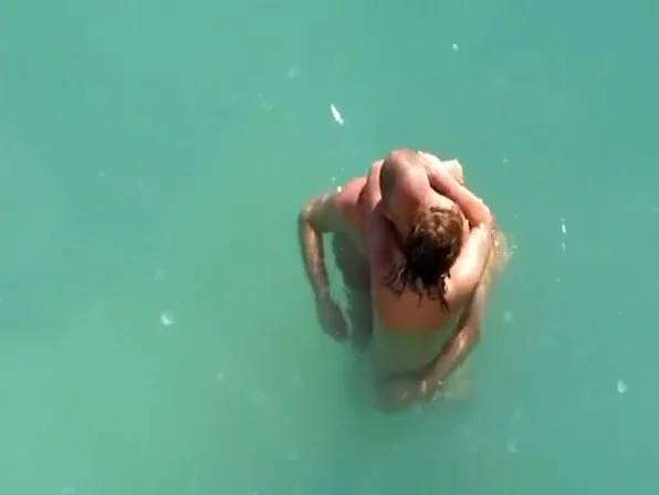 Nude couple fucking in water