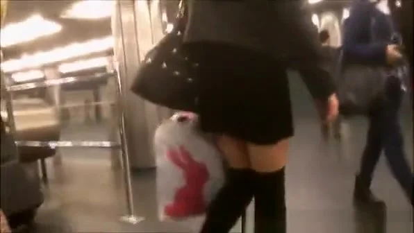 Woman in short black skirt and black socks upskirted