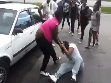 Angry black women fight in a parking lot