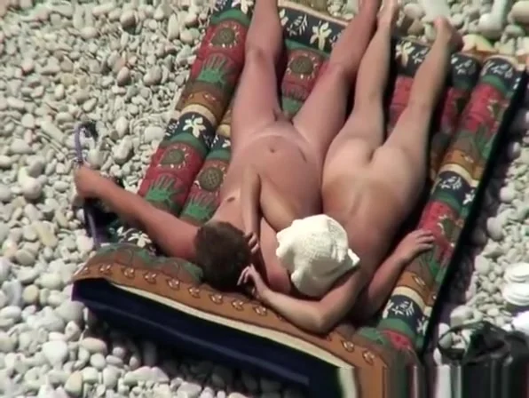 Nudist couple relaxing and sunbathing