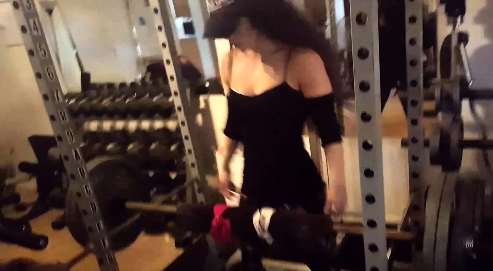 Fit babe working out at a gym with heavy weights