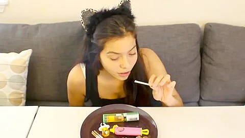 Young girl sucks lollipops
