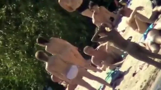 Young nudists take off their clothes to soak up some sun on