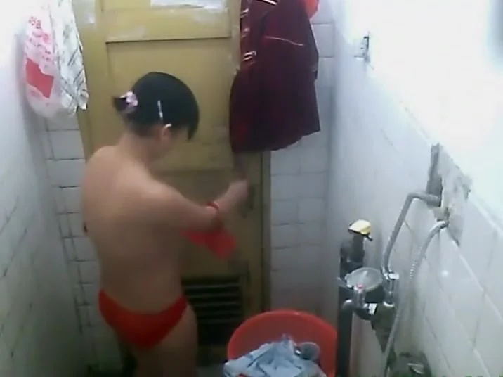 She removes costume and showers