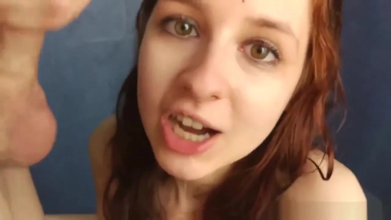 Sweet redhead gives sloppy blowjob in the shower