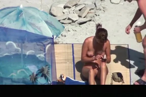 Nudist woman takes off her clothes