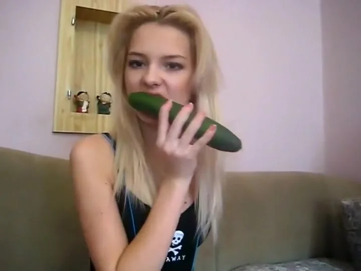 teen 18+ beauty plays with a cucumber