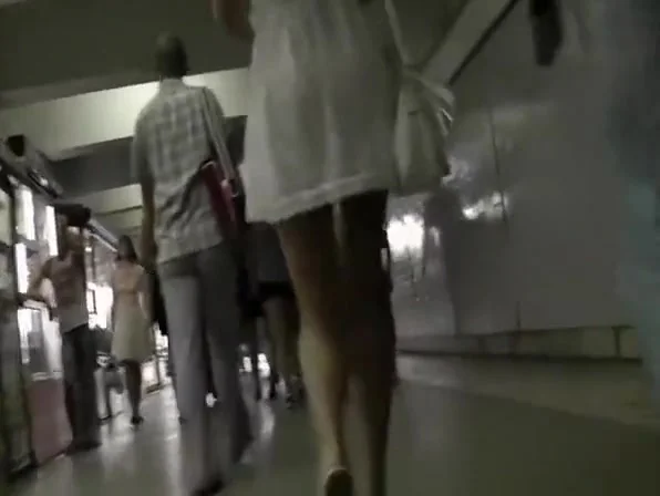 Blonde woman in short white dress upskirt