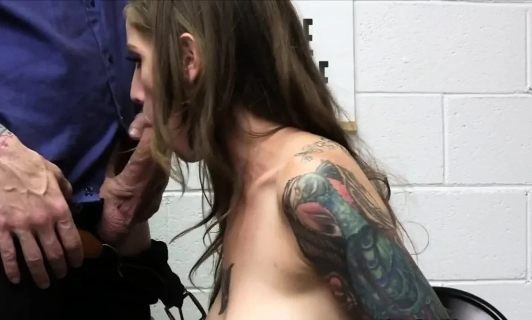 Inked busty MILF blows after strip search