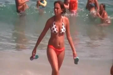 a brunette with a beautiful ass on the beach
