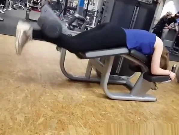 Chick in black sports pants exercising