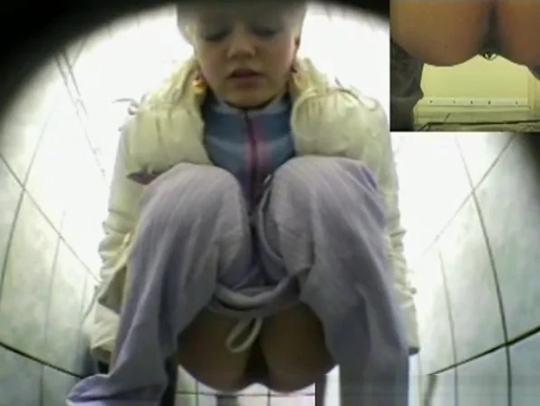 Cute blonde pissing in public toilet