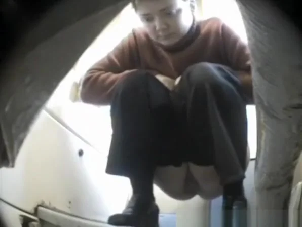Short hair woman pissing in toilet