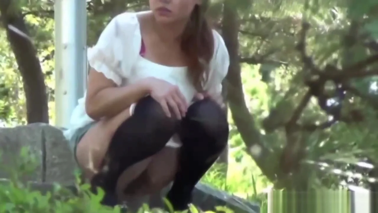 Asian babe pees crouching