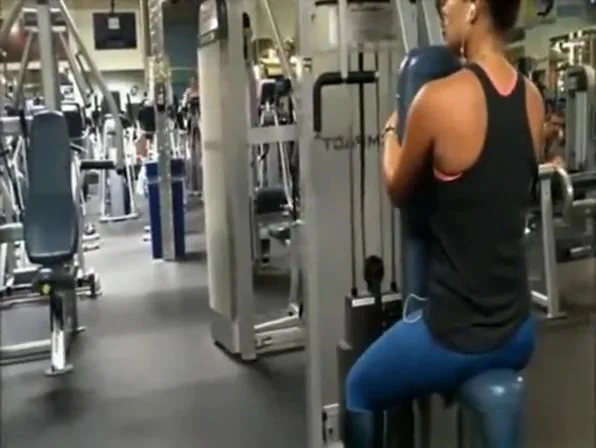 Chick in tight blue spandex pants exercising