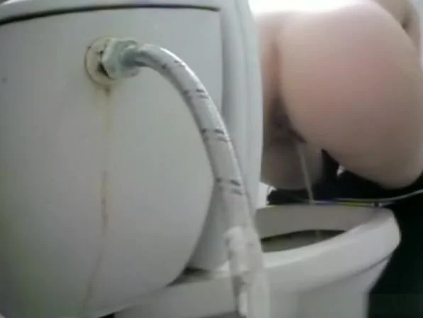 Woman takes a piss in toilet