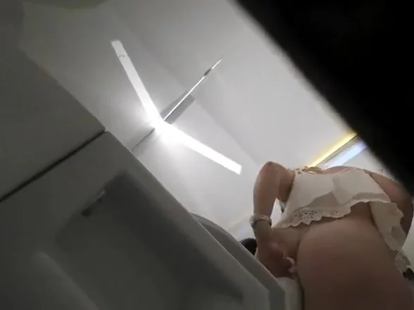 Woman caught seated in public toilet
