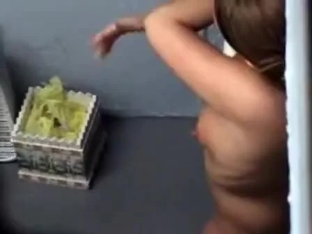 Cute chubby girl lotions up before a tan