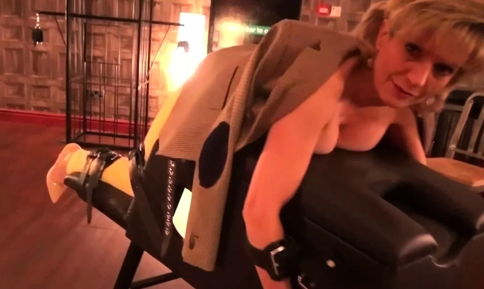 Lady Sonia caged and strips nude in the sex dungeon