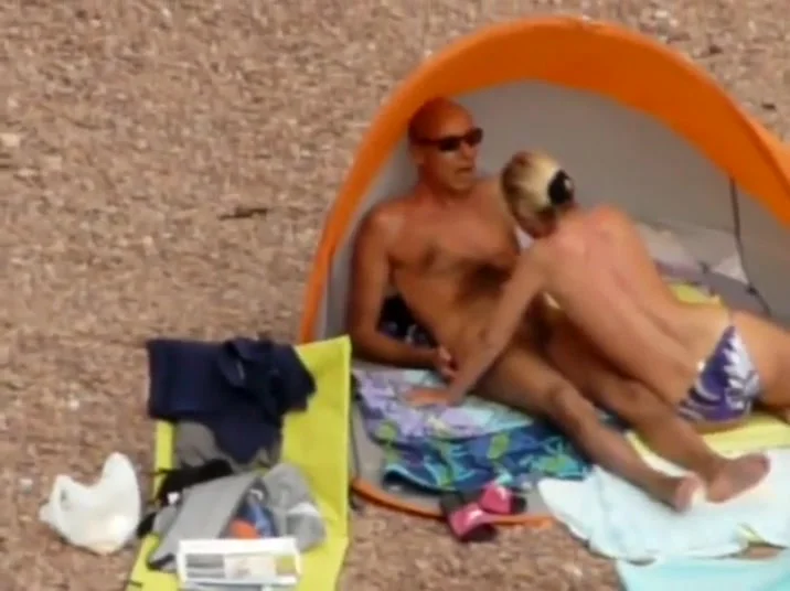 Milf strips down to enter the water