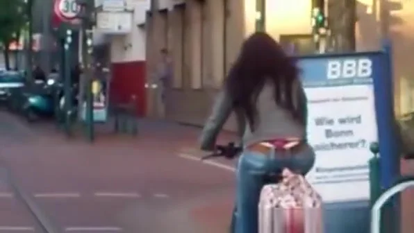Red thong woman riding bike