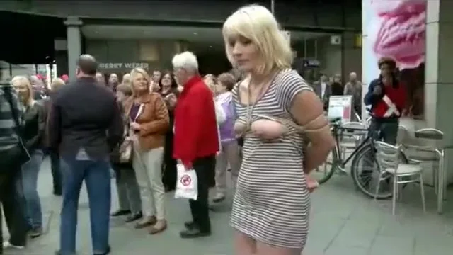 Submissive woman bound and exposed in public