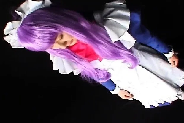 Japanese chick in costume and purple hair chews on his wanker