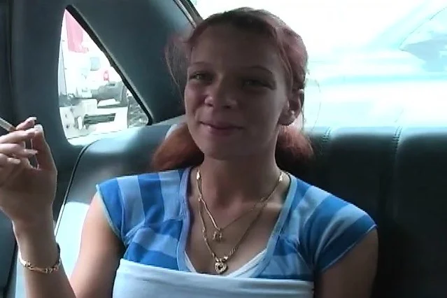 Ravishing redhead with big round boobs gives a nice blowjob in the car