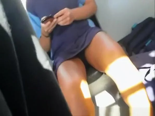 Girl with sexy legs texting in the bus