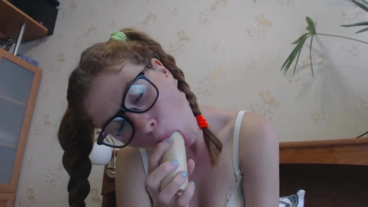 Little Lara makes a deep blowjob with a toy