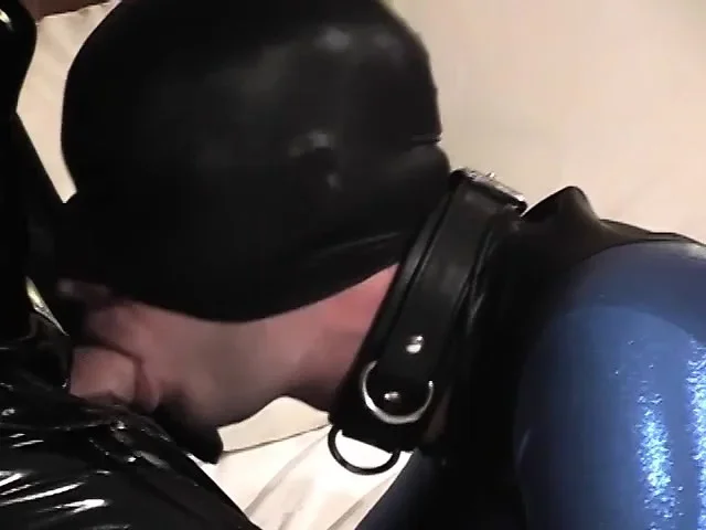 Stud clad in a skin-tight latex suit sucks his top's hard cock