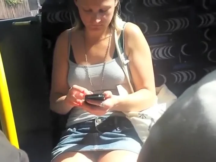 Upskirt sights of a girl texting in the bus