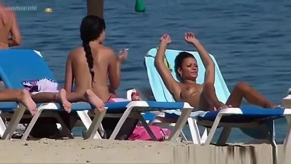 Pretty topless girls sunbathing on the beach