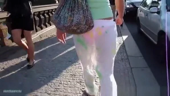 Girl in sheer pants walking on the bridge.