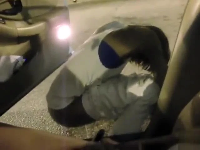 Black goddess urinates by the car